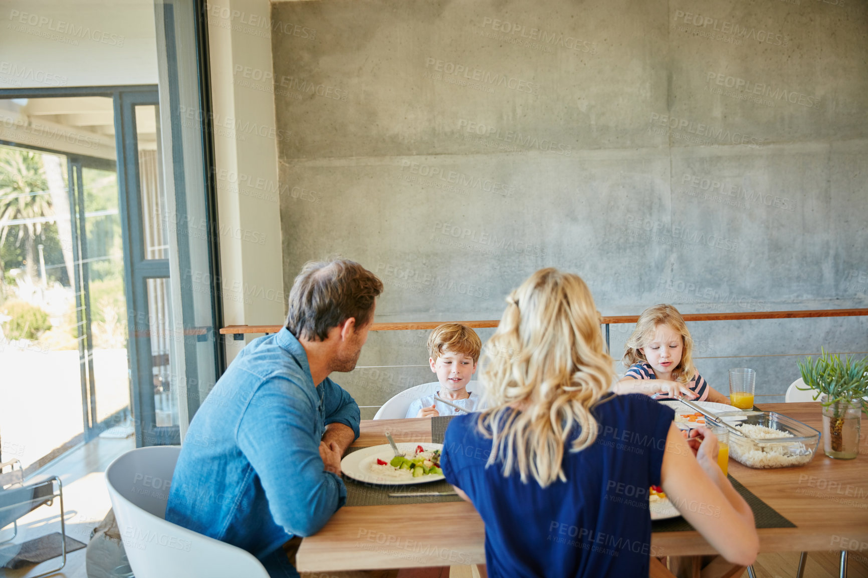 Buy stock photo Cropped shot of a family enjoying a meal together at home