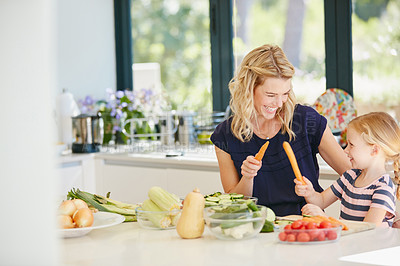 Buy stock photo Cropped shot of a mother and daughter preparing a meal together at home