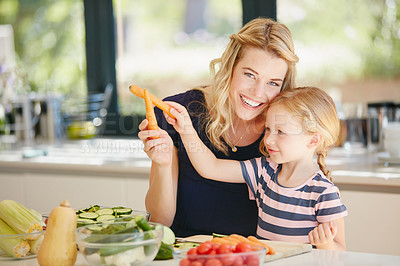 Buy stock photo Portrait of a mother and daughter preparing a meal together at home