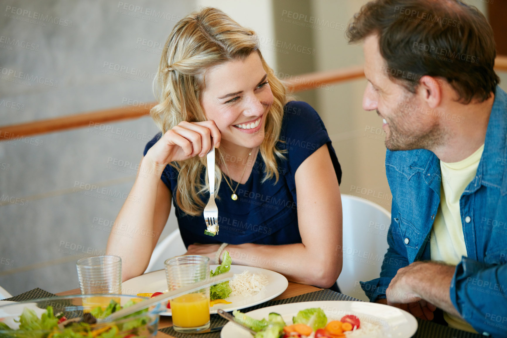 Buy stock photo Cropped shot of a couple enjoying a meal together at home