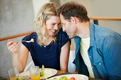 Buy stock photo Cropped shot of a couple enjoying a meal together at home