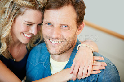 Buy stock photo Portrait of a happy young couple relaxing together at home