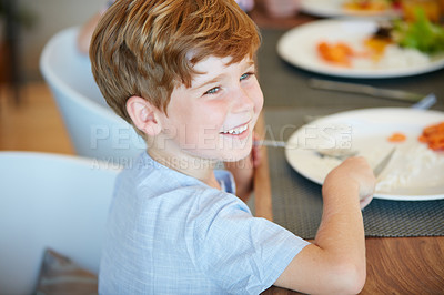 Buy stock photo Cropped shot of an adorable little boy enjoying a meal at home