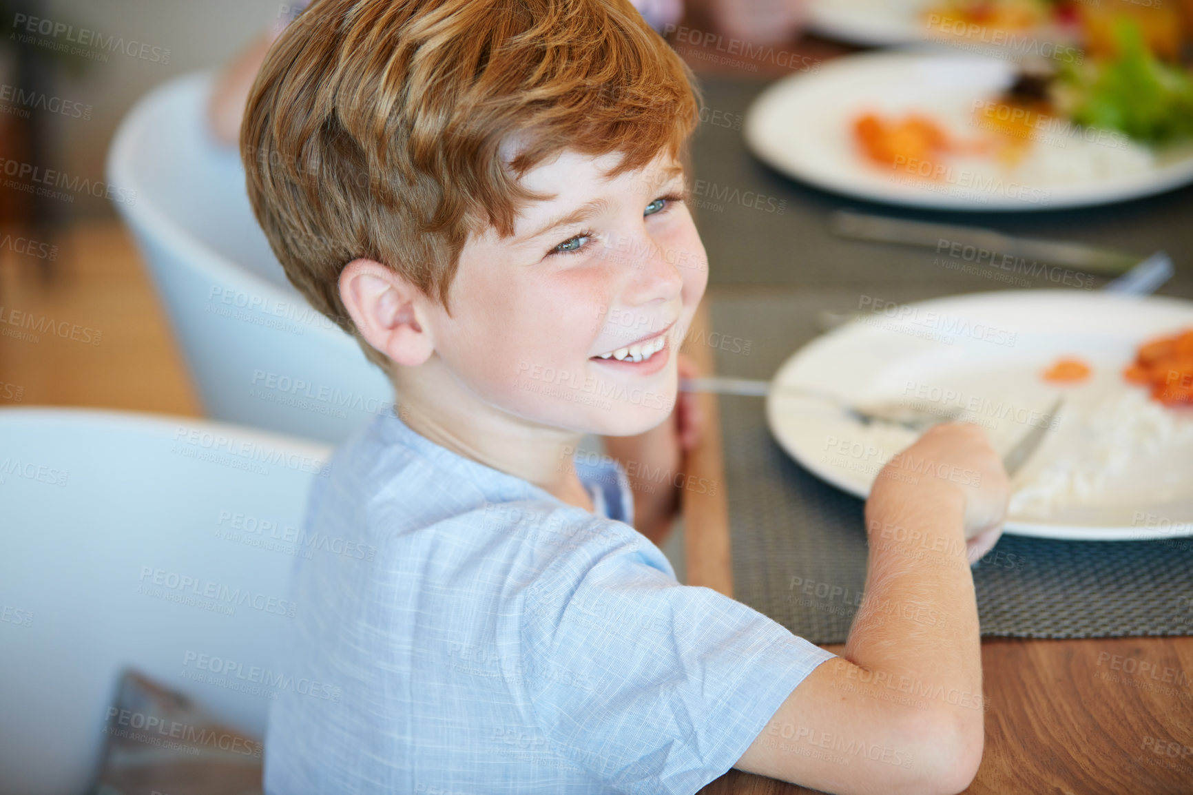 Buy stock photo Cropped shot of an adorable little boy enjoying a meal at home