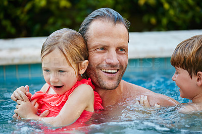 Buy stock photo Cropped shot of a father swimming in a pool with his son and daughter