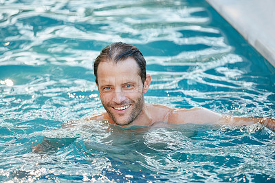 Buy stock photo Portrait of a handsome man swimming in a pool