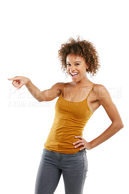 Buy stock photo Studio shot of an attractive young woman pointing towards something