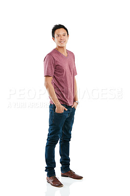 Buy stock photo Studio portrait of a young man posing with his hands in his pockets against a white background