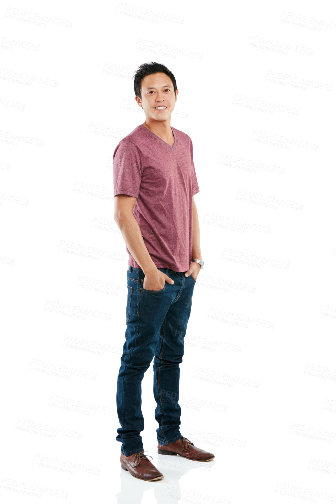 Buy stock photo Studio portrait of a young man posing with his hands in his pockets against a white background