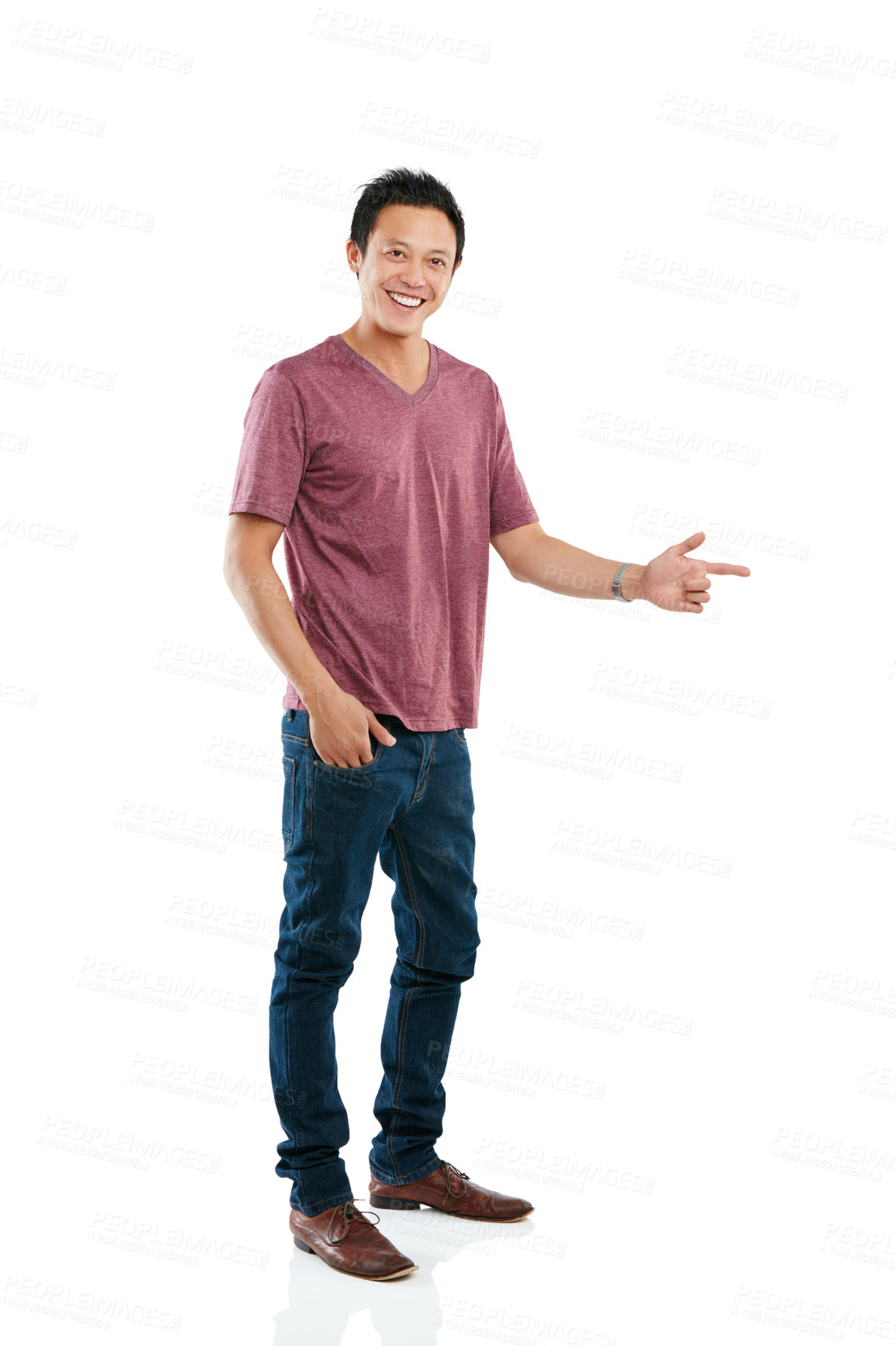 Buy stock photo Studio portrait of a young man pointing at blank copyspace while standing against a white background