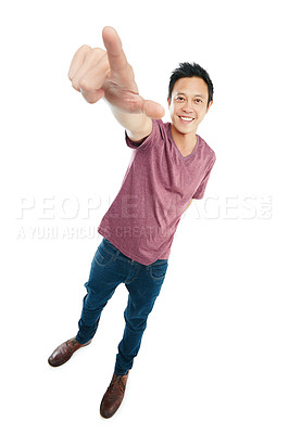 Buy stock photo Tilted studio portrait of a young man pointing upwards against a white background