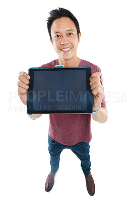 Buy stock photo Studio portrait of a young man holding up a blank tablet against a white background