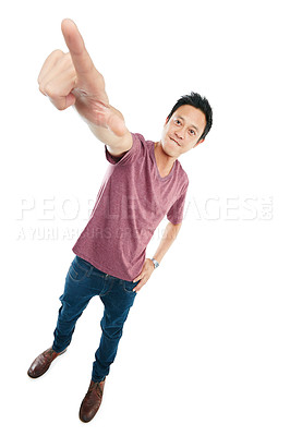 Buy stock photo Tilted studio portrait of a young man pointing upwards against a white background