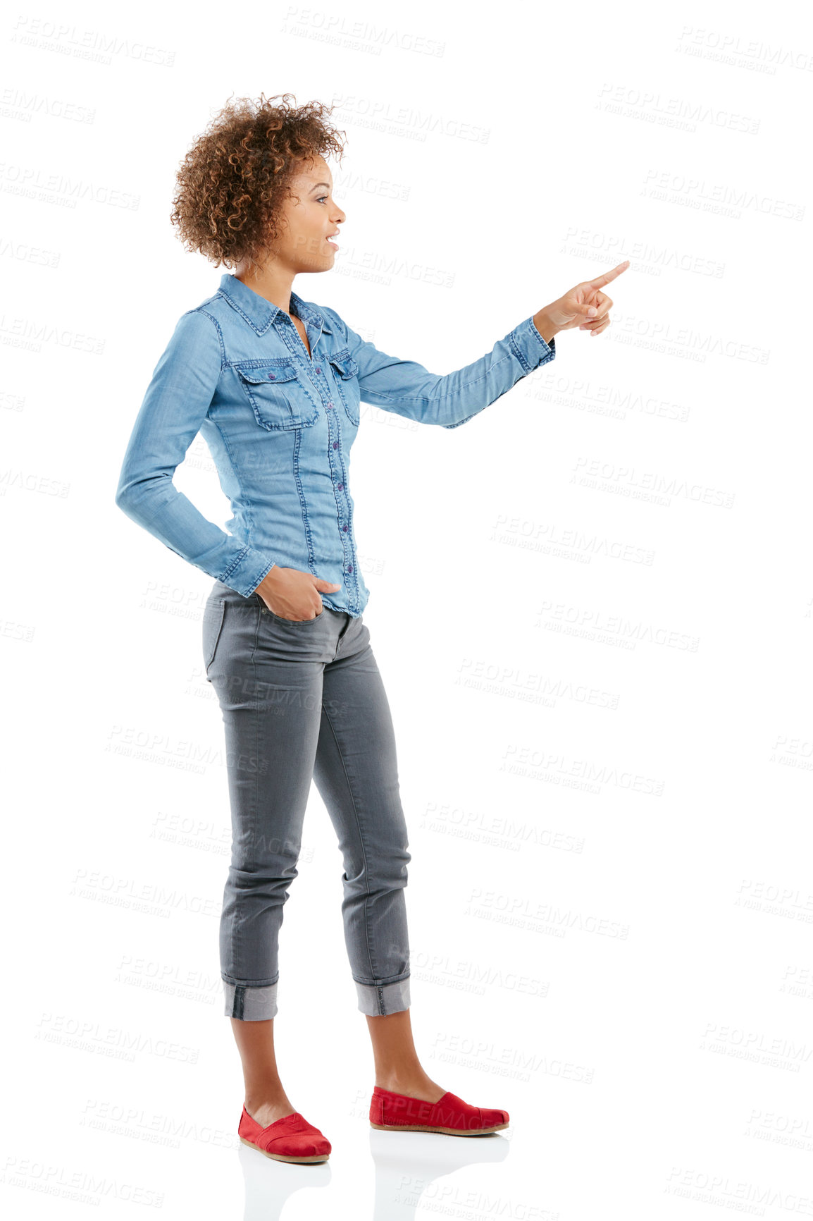 Buy stock photo Studio shot of an attractive young woman pointing towards something