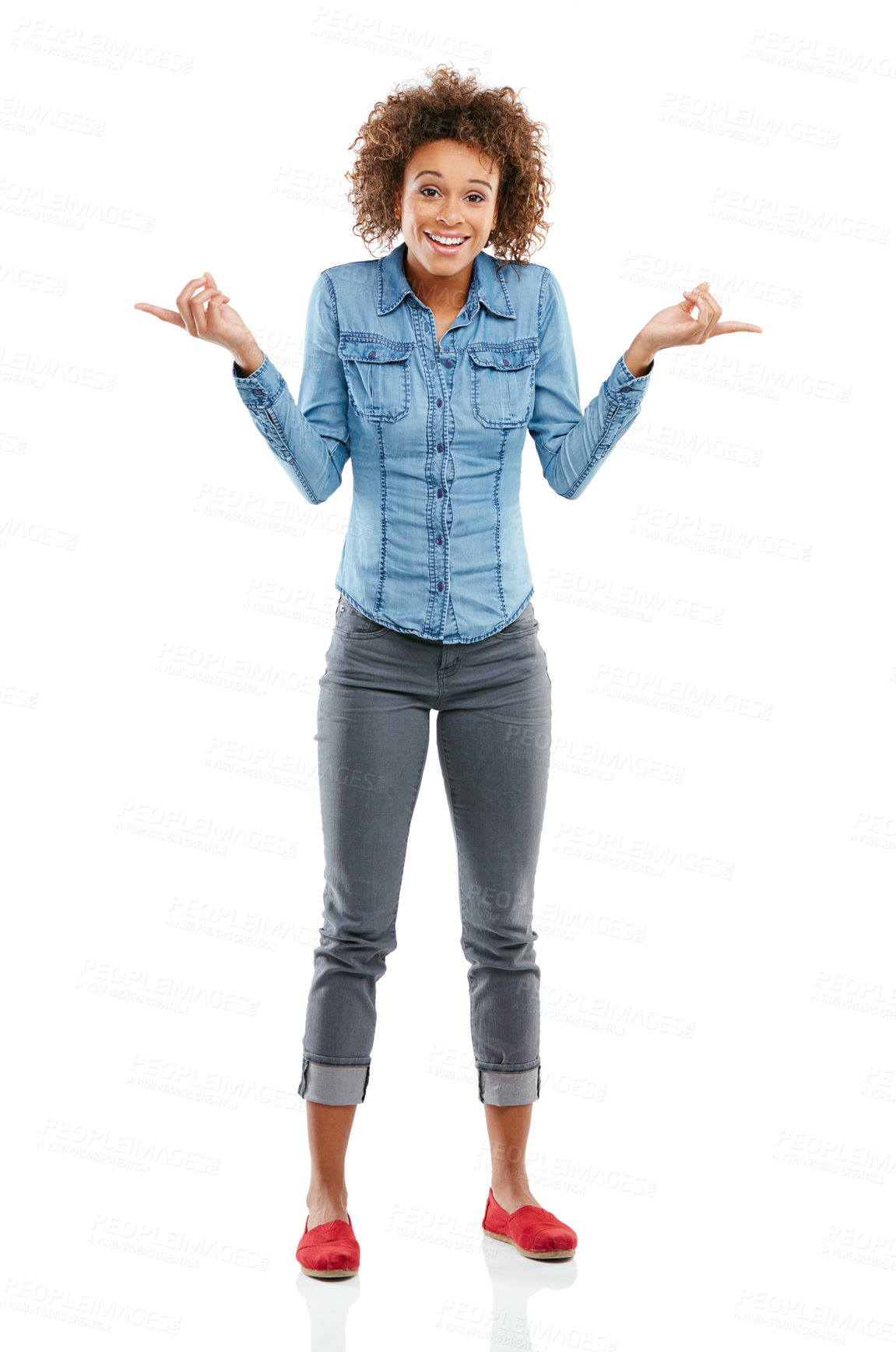 Buy stock photo Studio shot of an attractive young woman pointing in two different directions