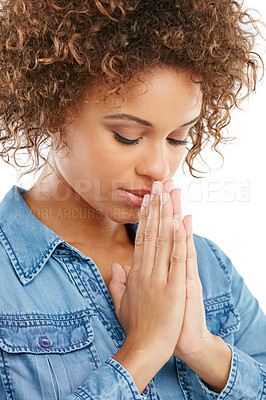 Buy stock photo Shot of a young woman standing with her hands together in a hopeful gesture