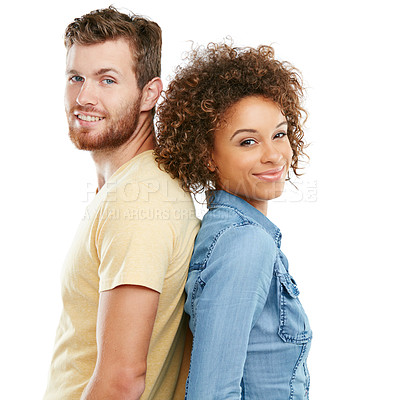 Buy stock photo Studio portrait of an affectionate young couple standing back to back against a white background