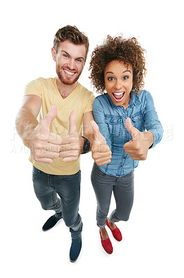 Buy stock photo Studio portrait of a young couple giving a thumbs up to the camera against a white background