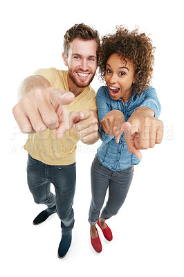 Buy stock photo Studio portrait of a young couple poitning at the camera against a white background