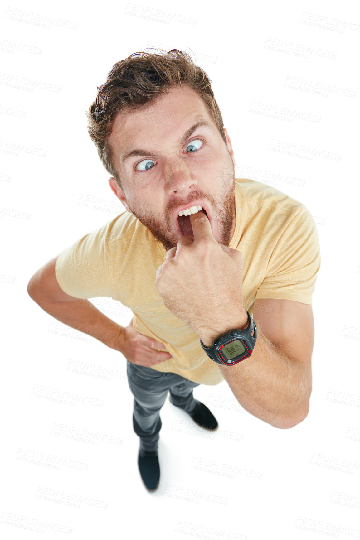 Buy stock photo Studio portrait of an angry young man sticking his finger down his throat against a white background