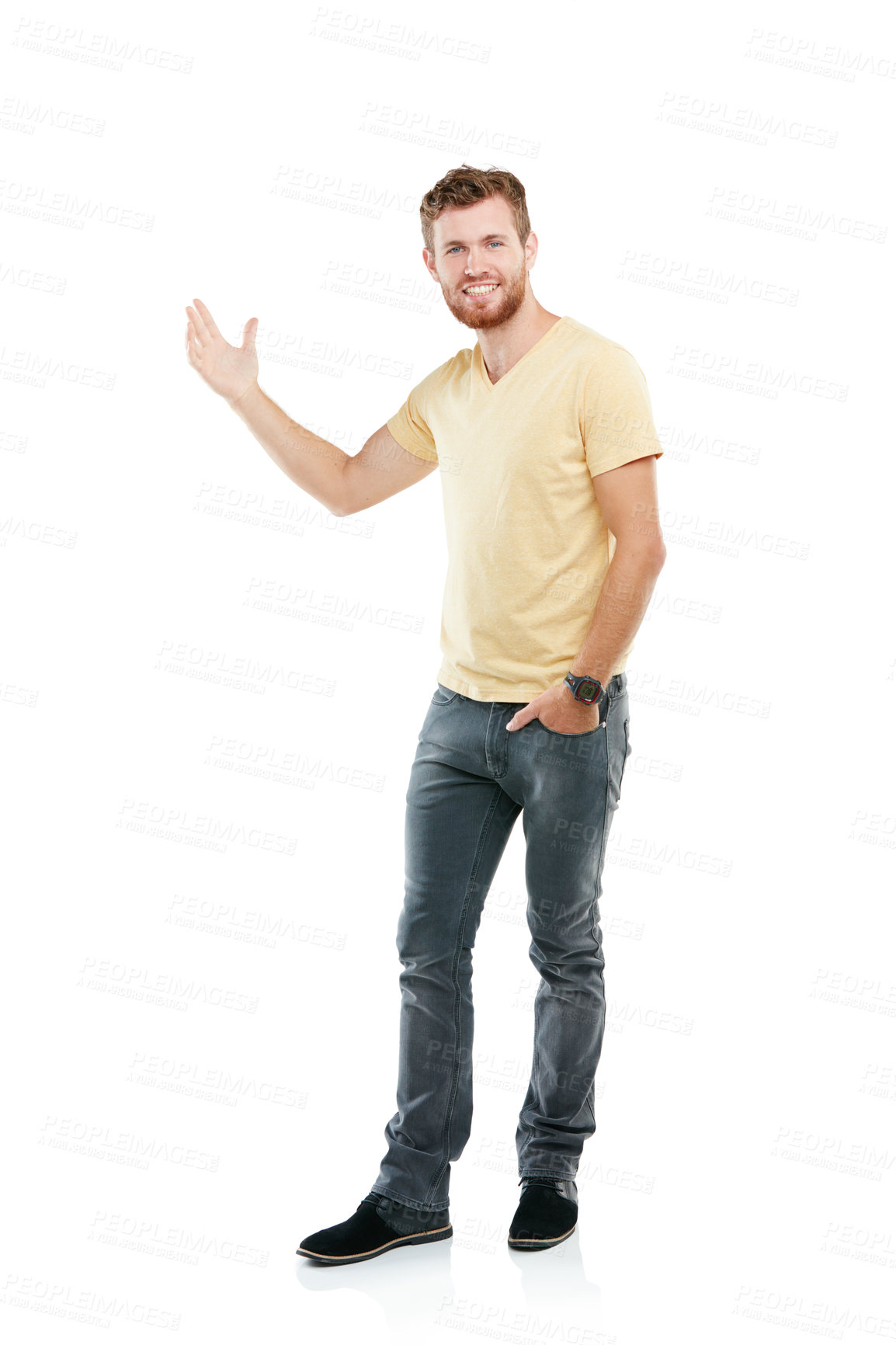 Buy stock photo Studio portrait of a young man pointing at blank copyspace while standing against a white background