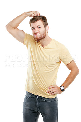 Buy stock photo Studio portrait of a young man scratching his head in puzzlement against a white background