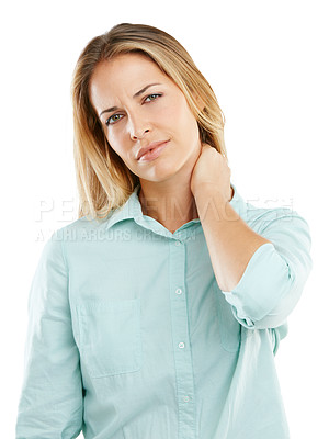 Buy stock photo Shot of an unhappy woman rubbing her sore neck against a white background