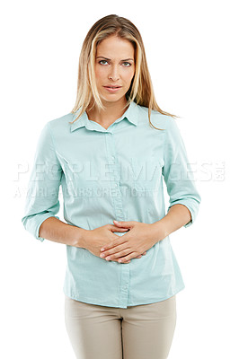 Buy stock photo Shot of an unhappy woman holding her sore stomach against a white background