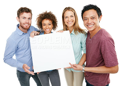 Buy stock photo Studio portrait of a group of friends holding up a blank sign against a white background