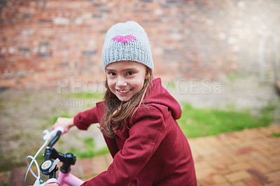 Buy stock photo Portrait of a little girl riding her bicycle outside