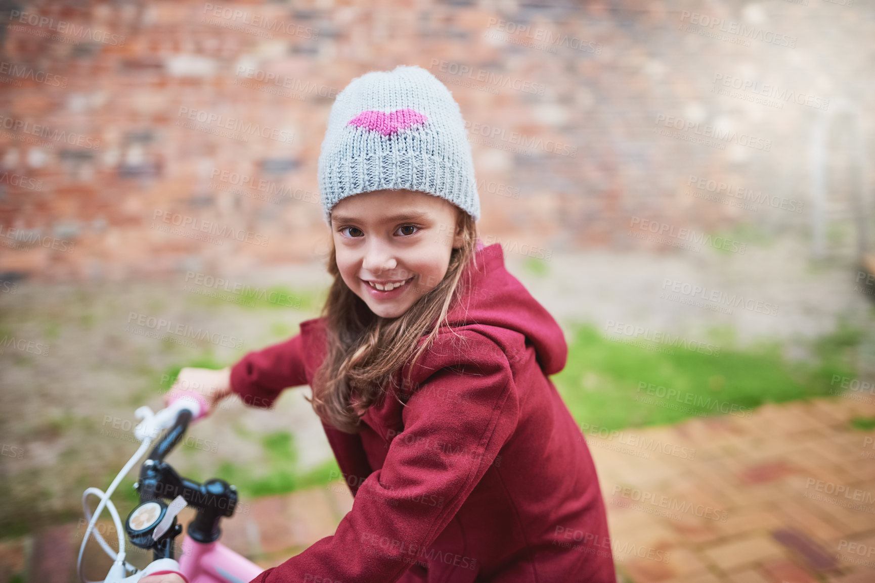 Buy stock photo Little girl, portrait and riding in neighborhood with bicycle for learning, hobby or outdoor activity. Female person, child or kid cycling with bike for playful adventure, journey or trip at park