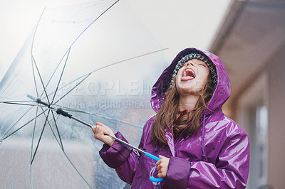 Buy stock photo Cropped shot of a young girl standing with an umbrella outside