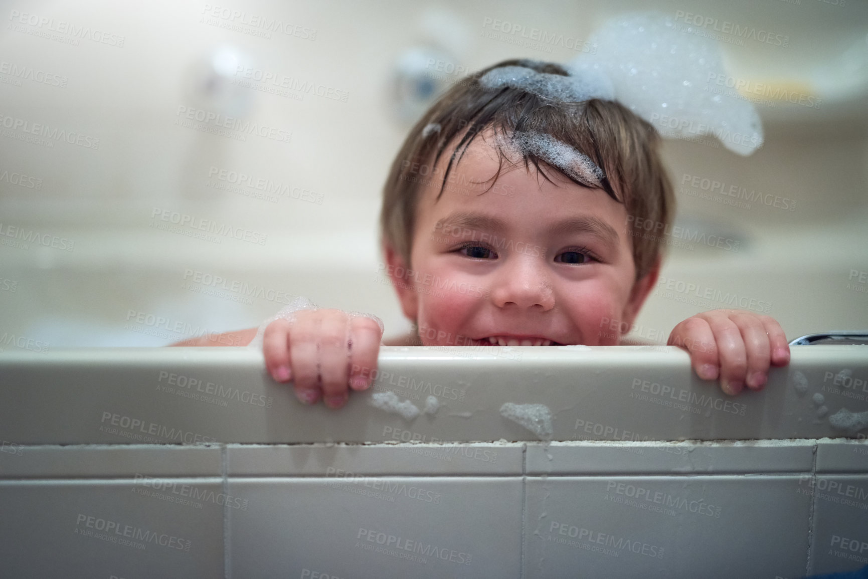 Buy stock photo Portrait of a little boy sitting in a bathtub