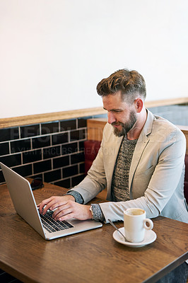 Buy stock photo Cropped shot of a modern businessman using his laptop in a coffee shop