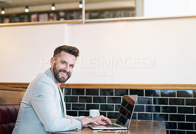 Buy stock photo Cropped portrait of a modern businessman using his laptop in a coffee shop