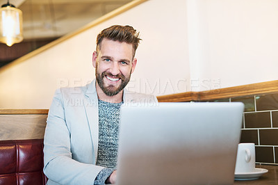 Buy stock photo Cropped portrait of a modern businessman using his laptop in a coffee shop