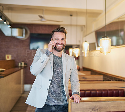 Buy stock photo Cropped shot of a modern businessman using his cellphone in a coffee shop