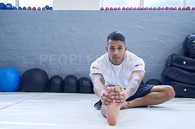 Buy stock photo Portrait of a young man warming up in the gym