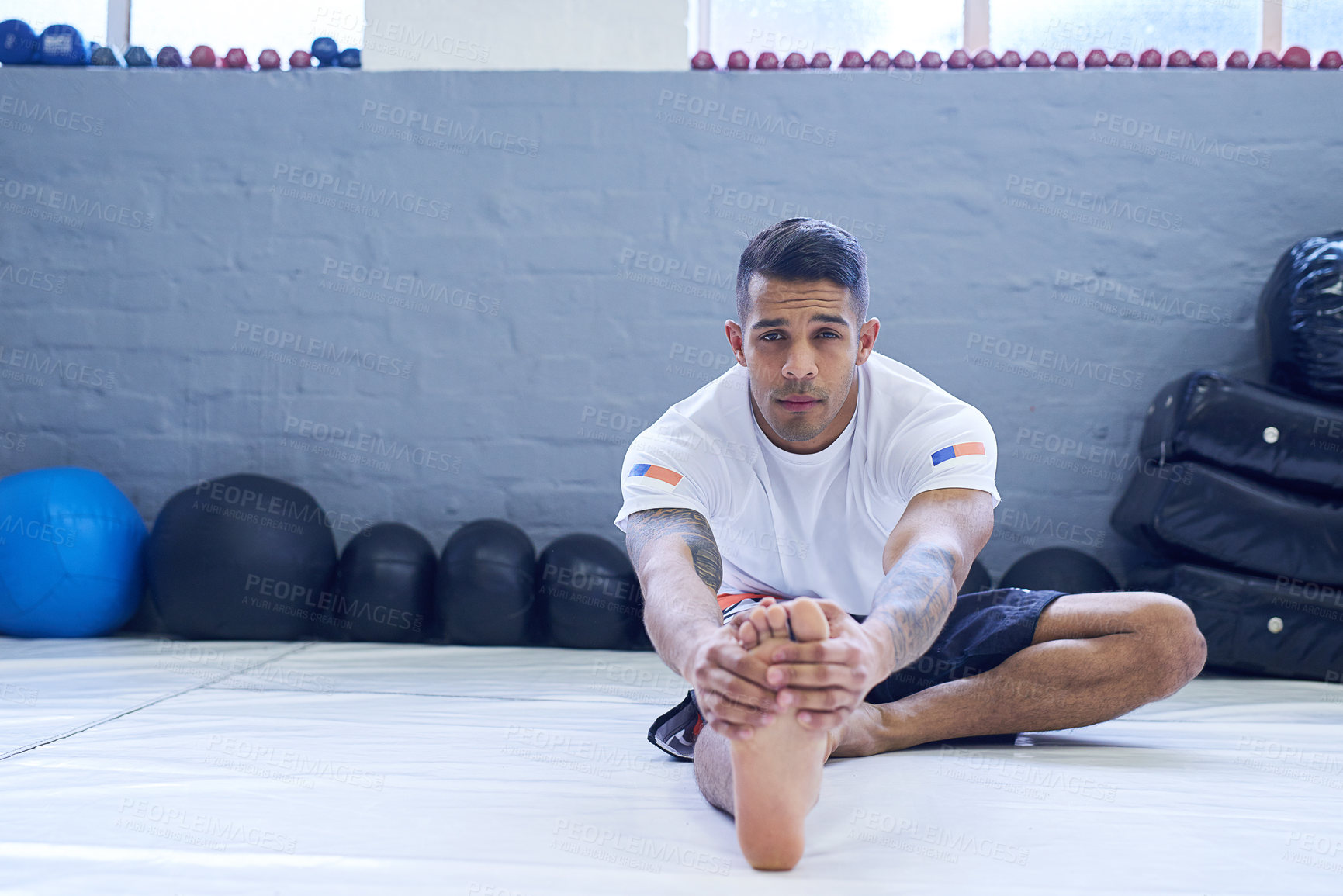 Buy stock photo Portrait of a young man warming up in the gym