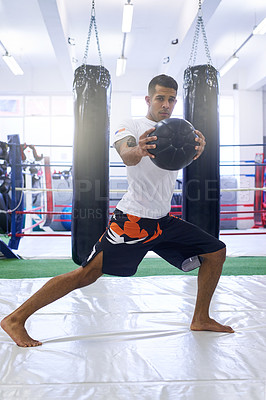 Buy stock photo Man, boxer and fitness with ball in gym for workout or training with motivation for health or wellness as fighter. Active, male person and exercise by boxing with power for strength or cardio for mma