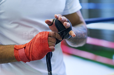 Buy stock photo Gym, boxer or man wrapping hands for training, exercising and workout for competition. Professional, mma fighter or male athlete in ring ready with energy, commitment and boxing with motivation