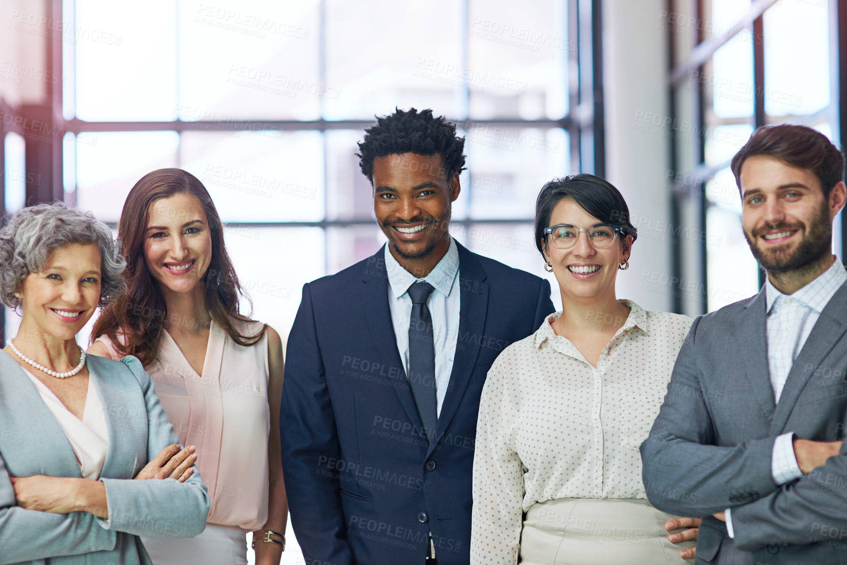 Buy stock photo Portrait of a diverse team of professionals standing together in a modern office