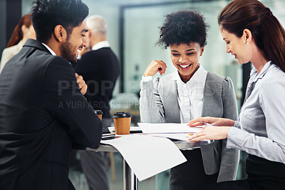 Buy stock photo Shot of a group of businesspeople talking together while sitting at a table in an office