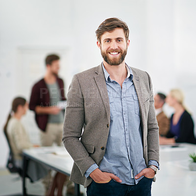 Buy stock photo Portrait of a young businessman in an office with colleagues in the background