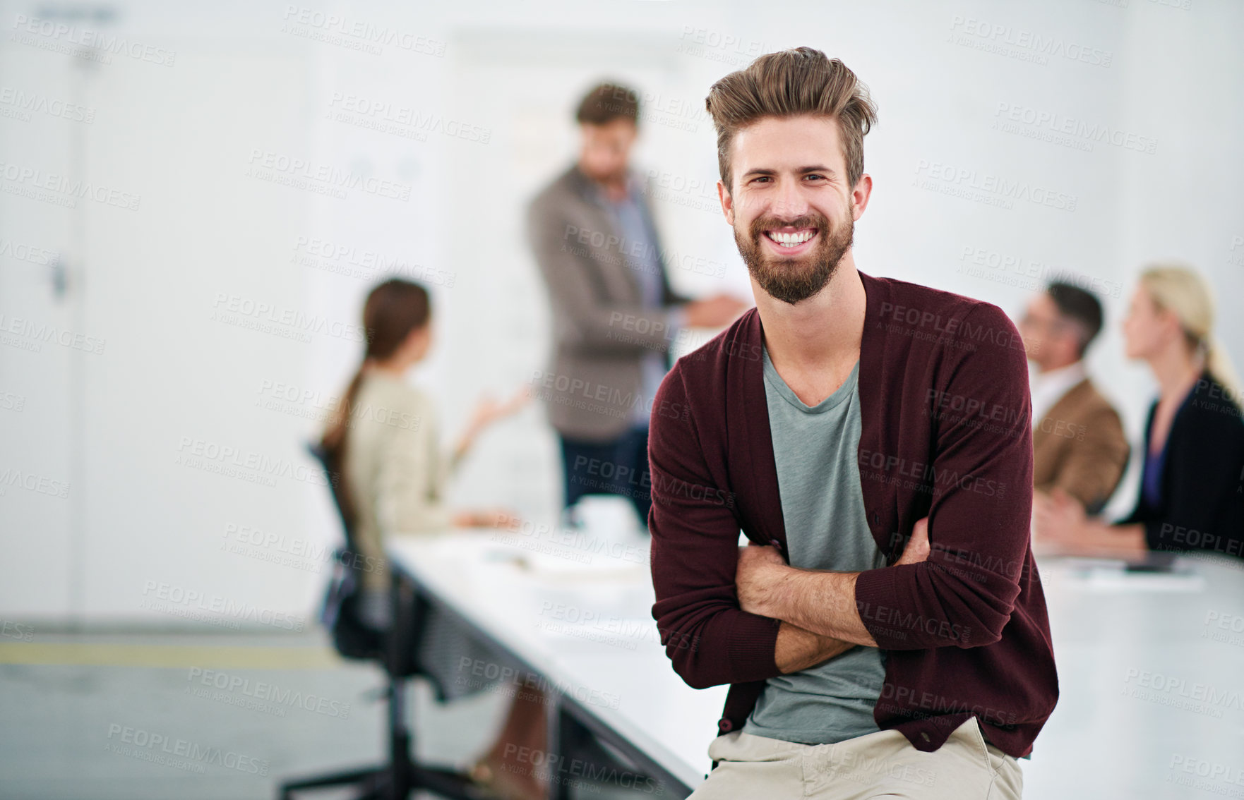 Buy stock photo Portrait of a young businessman in an office with colleagues in the background