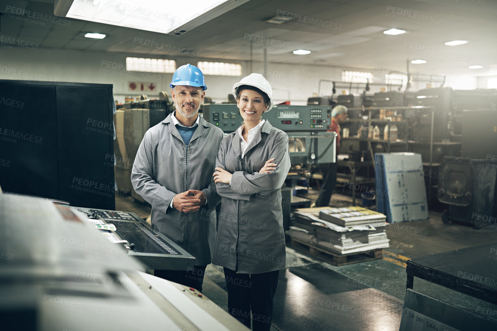 Buy stock photo Man, woman and printing press for industry with smile in factory in portrait with team, packaging and manager. People, workers and together in warehouse for manufacturing with industrial production