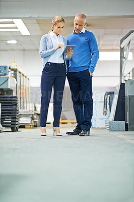 Buy stock photo Senior, man and woman with tablet in factory for production monitoring, inventory or order management and inspection. Team, digital tech and warehouse for printing material and distribution industry.