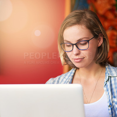 Buy stock photo Shot of a happy young woman using her laptop at home