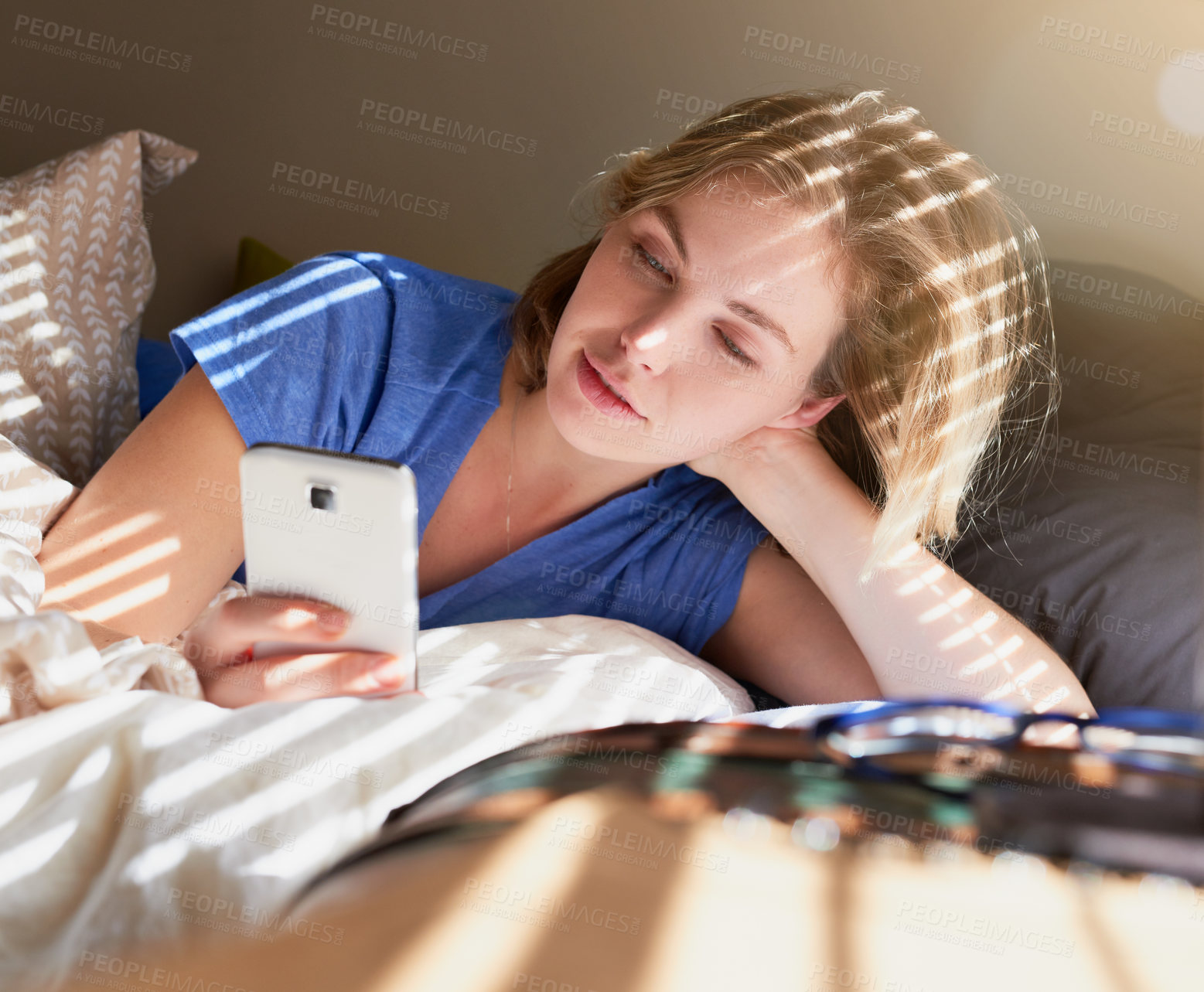 Buy stock photo Woman, bed and relax with phone for search on social media, technology or video call in bedroom. Female person, mobile and scroll for news on digital in Europe, check with application for new story