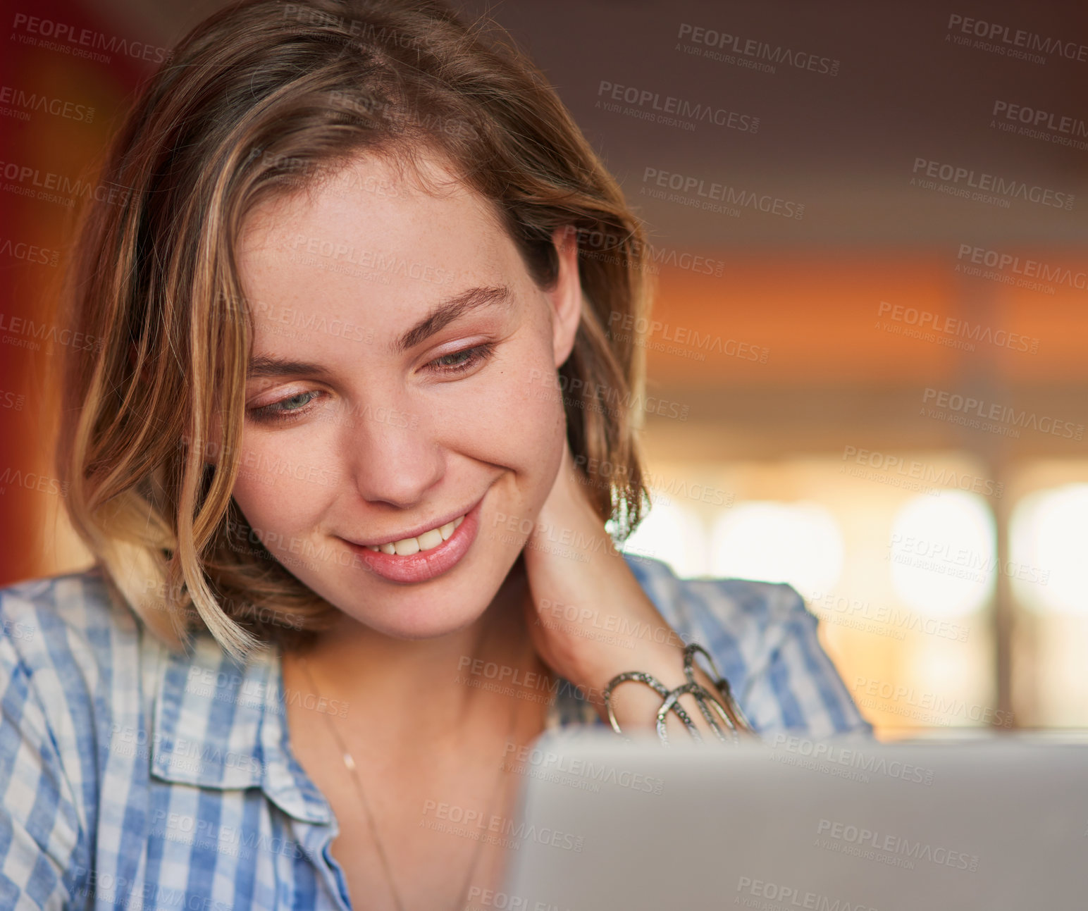 Buy stock photo Shot of a happy young woman using her laptop at home